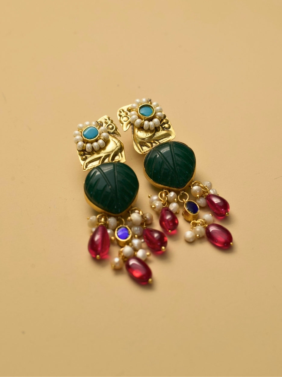 Gold polished peacock earrings with green carved center and pearl drops