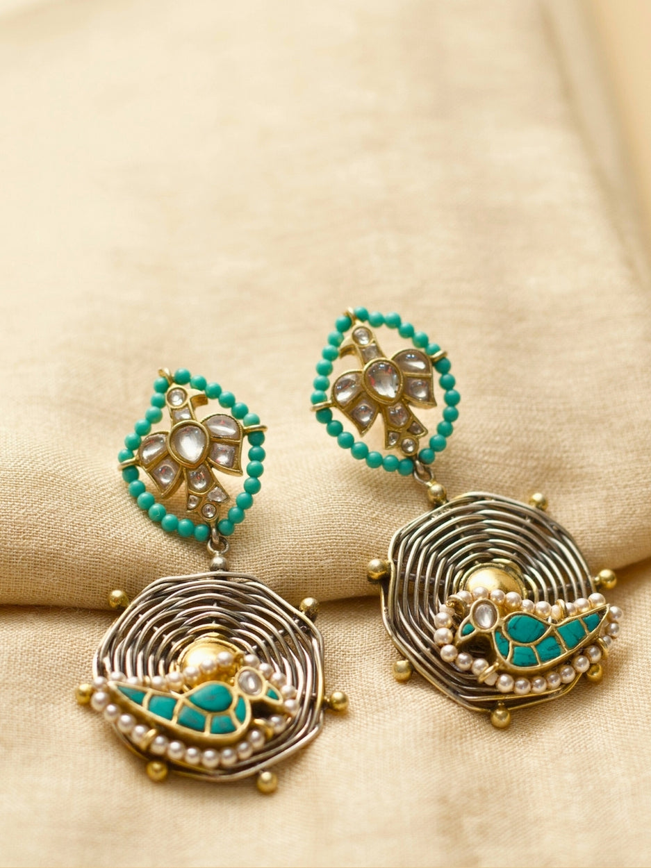 Sky Whisper Earrings in 925 silver with gold polish, eagle and parrot design, teal stone center – handcrafted by Naksa