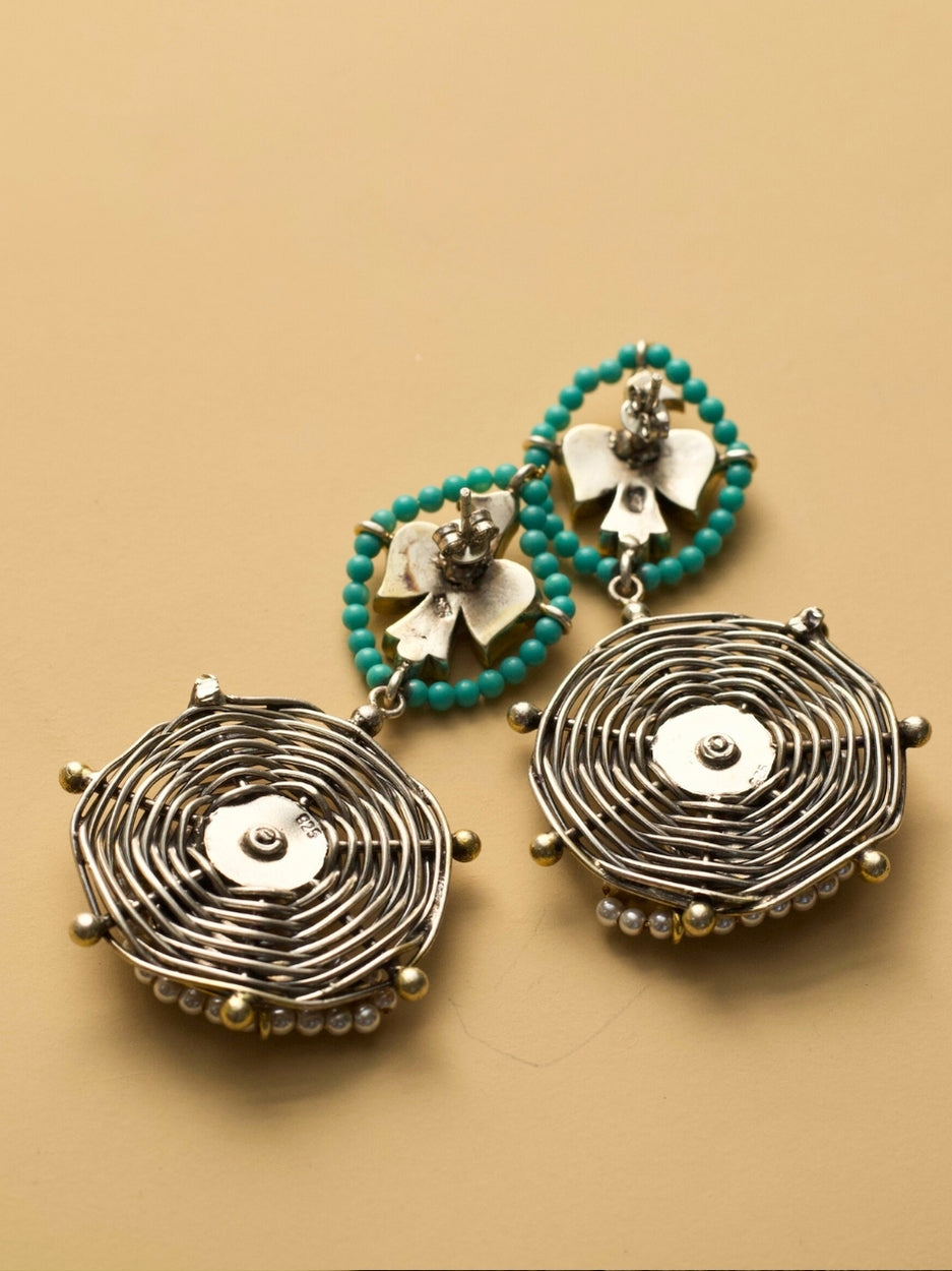 Sky Whisper Earrings in 925 silver with gold polish, eagle and parrot design, teal stone center – handcrafted by Naksa