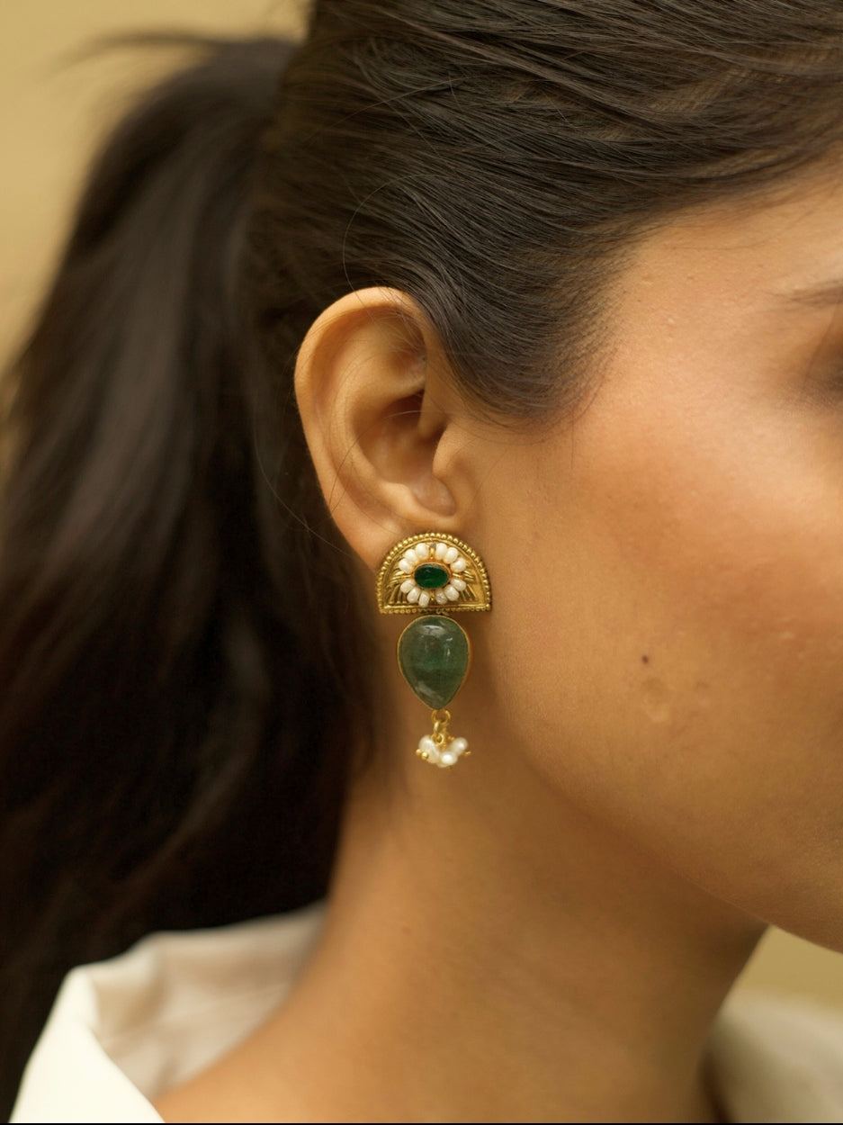 Aurora Drops Earrings by Naksa with golden half-sun motif, translucent green stone, and pearl accents.