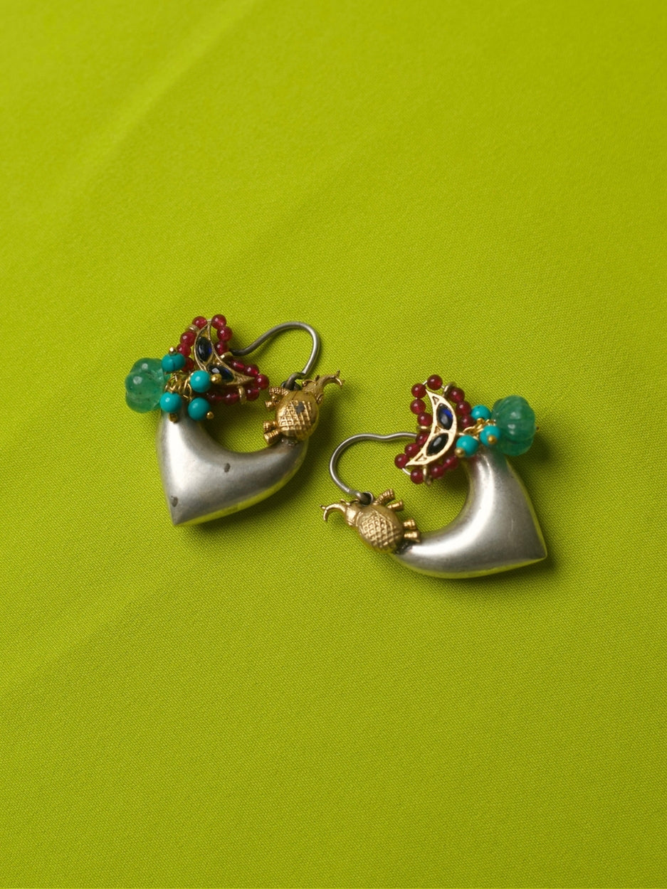 Heart-shaped 92.5 silver hoop earrings with golden elephant, green bead, turquoise and red accents, and crescent motif on lime green backdrop