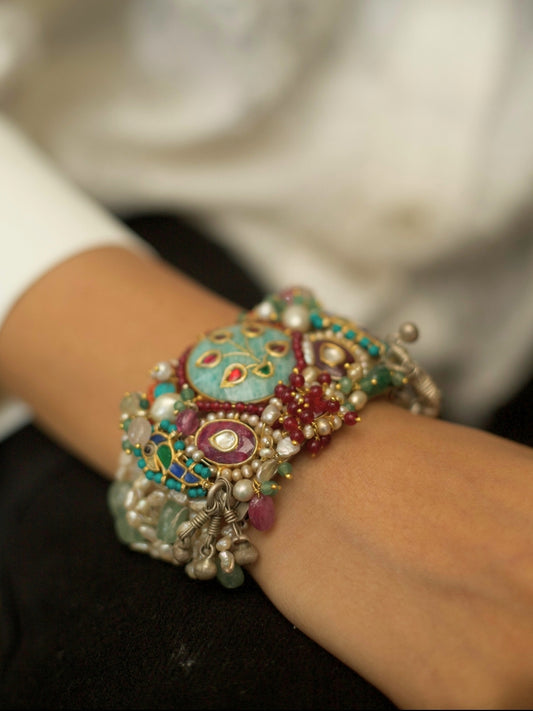 Exquisite pearl and kundan bracelet in pure 925 silver with sea-green, teal, blue, and red stones by Naksa.