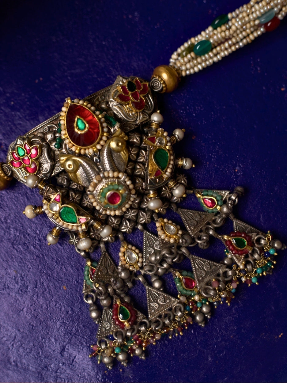 Close-up of She Who Embellishes silver choker necklace featuring kundan work, pearl strands, gold accents, and temple-style motifs from Naksa.