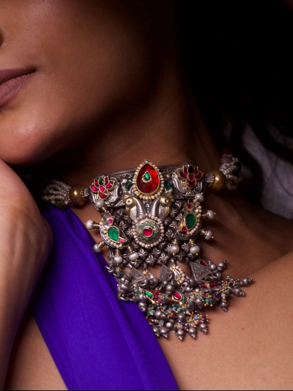 Close-up of She Who Embellishes silver choker necklace featuring kundan work, pearl strands, gold accents, and temple-style motifs from Naksa.