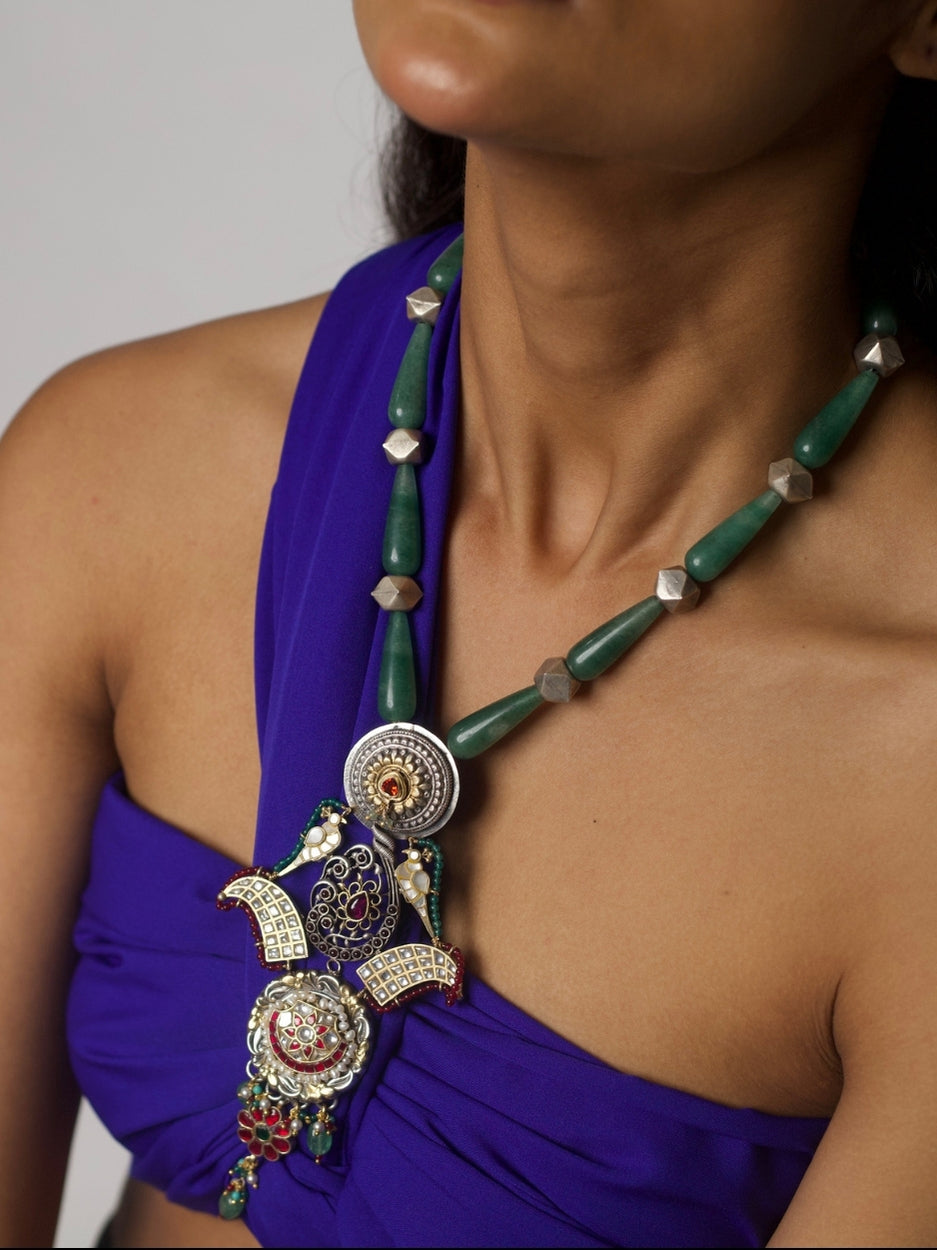 Long handcrafted 92.5 silver necklace with eclectic circular pendants, enamel, moissanite, temple and floral motifs.