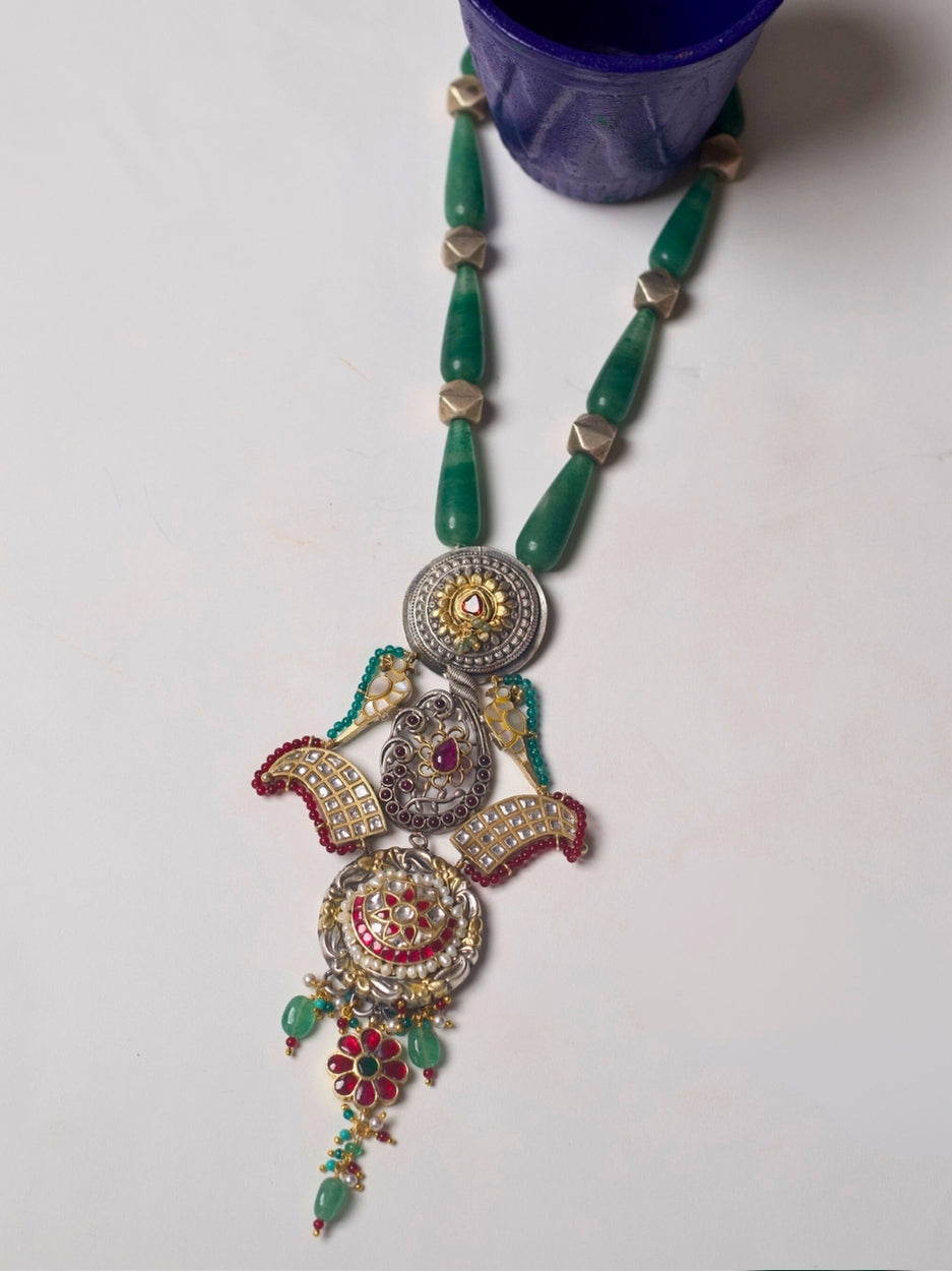 Long handcrafted 92.5 silver necklace with eclectic circular pendants, enamel, moissanite, temple and floral motifs.