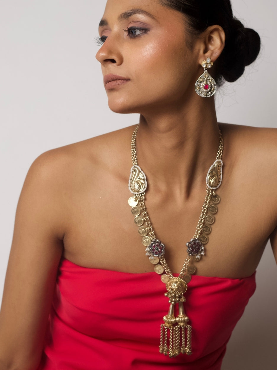 Sikka-inspired gold-silver necklace set with coin chain, floral accents, temple dome pendant, and matching kundan earrings.