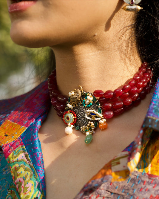 925 silver oxidised statement choker with red oval beads, elephant charm, bird motif, pearl drops, green and orange stone accents, and gold polish detailing.