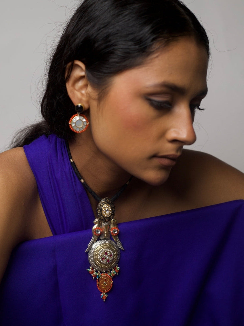 Close-up of The Courtship Collar Set – handcrafted silver necklace with twin parrot motifs, kundan inlays, enamel work, and matching round earrings from Naksa.