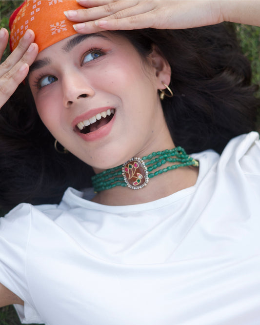 Four-strand green beaded 925 silver choker with gold-polished oval centre, pearl border and pink-green bird motif detailing.