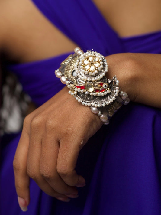 Pure 92.5 silver statement cuff with red enamel fish, kundan floral center, and pearl detailing – Eyes of the Sea Cuff by Naksa