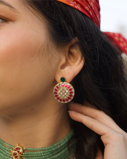 Round pink and white kundan stud earrings in gold polished 925 silver with green top stone accent.