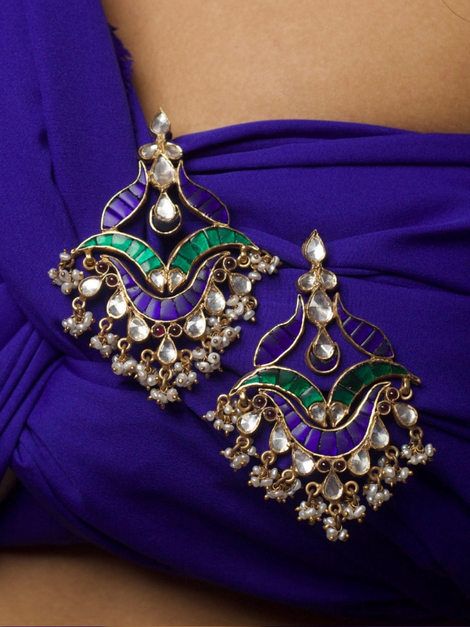 Close-up of Kalgi Silver Earrings in 92.5 silver featuring kundan stones, green and purple enamel, and pearl detailing.