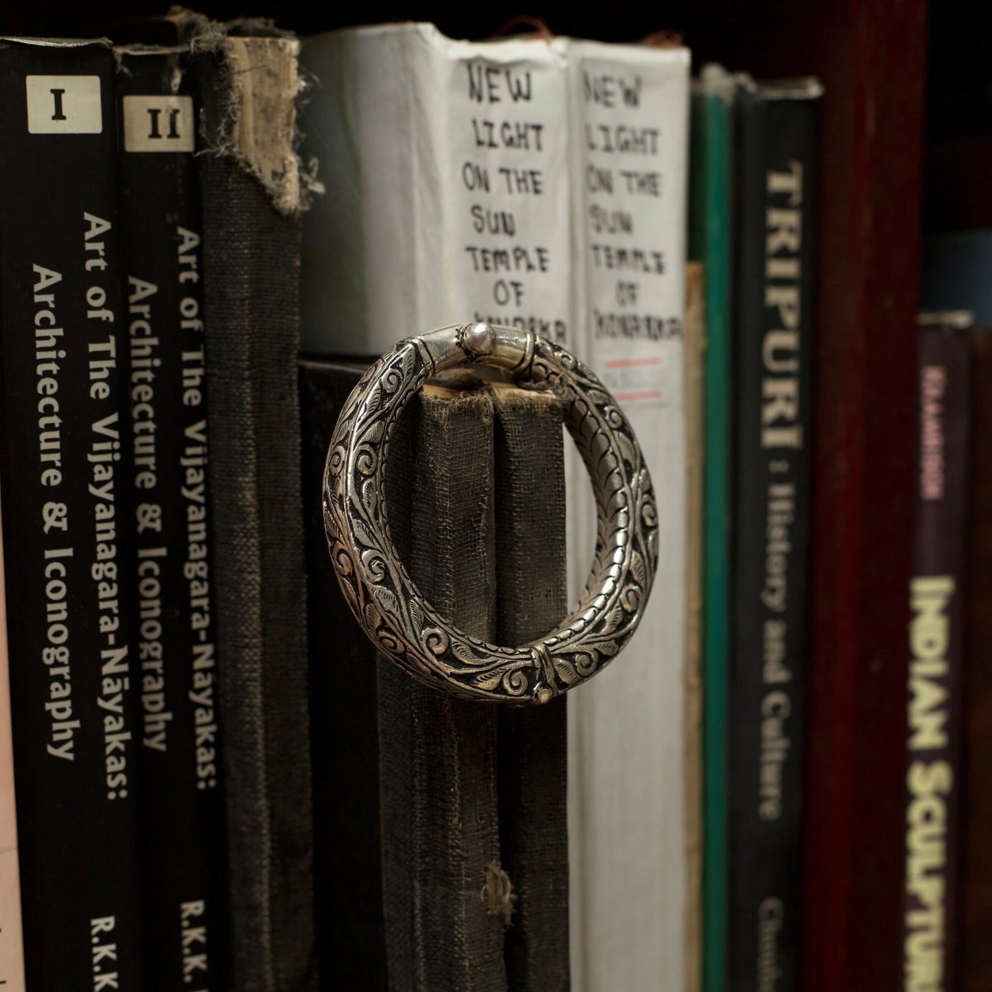 With winding vines nodding to the wisdom flowing through millenniums and the rustic dark finish of oxidised silver, this handcrafted engraved silver bangle comes with an adjustable toggle clasp. This bangle fits perfectly on your wrists and is durable and lightweight.