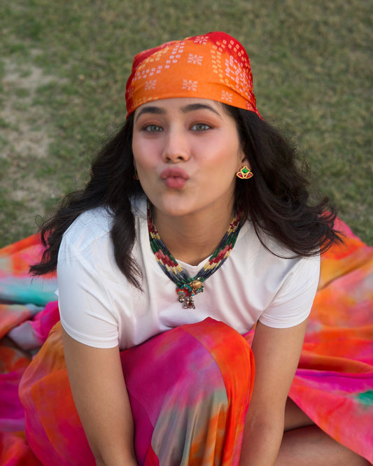 Colorful multi-strand beaded necklace in blue, green, red and ivory tones with central charm cluster featuring elephant, bird and gold polished 925 silver detailing