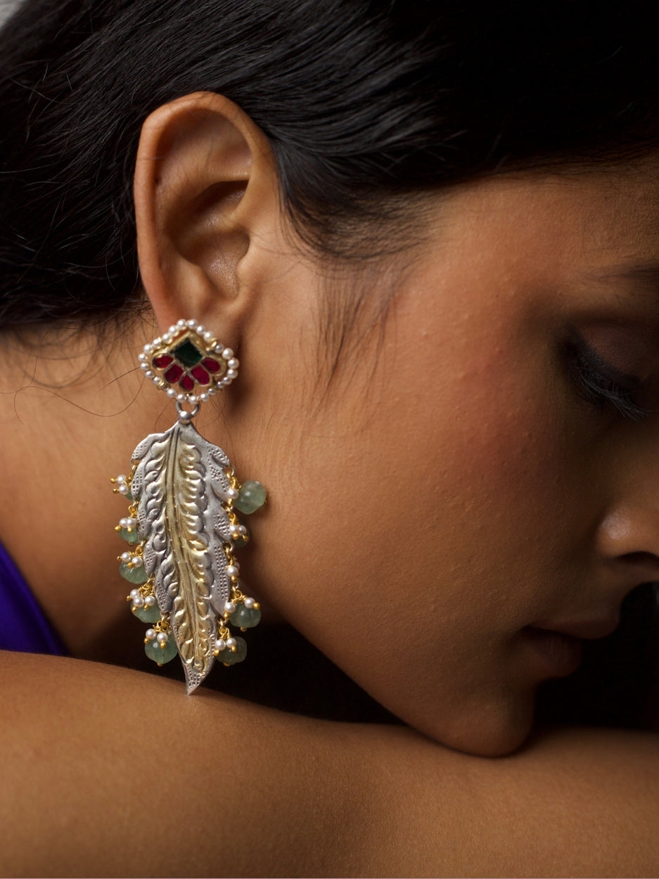 Close-up of Forest Muse Earrings in 92.5 silver with sculpted leaf design, gold accents, green stone drops, and kundan floral stud