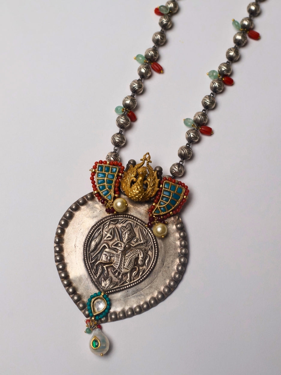 Antique silver Lakshmi pendant necklace with turquoise enamel tusk motifs, moonga and pearl accents, handcrafted in tribal style.