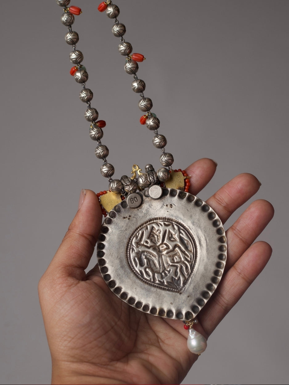 Antique silver Lakshmi pendant necklace with turquoise enamel tusk motifs, moonga and pearl accents, handcrafted in tribal style.