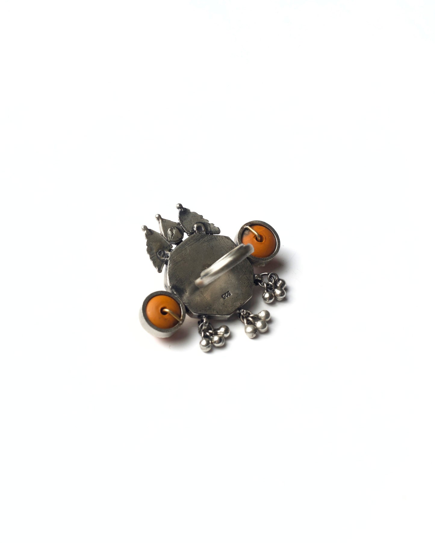 Back view of Devika Shield Ring in 925 silver with gold-toned goddess central relief, coral side discs, red stone crown, and silver drop detailing