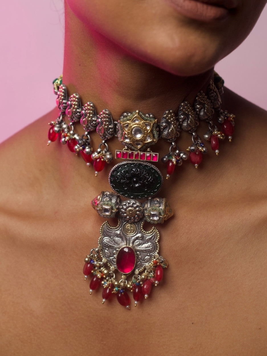 Close-up of The Garland Choker in 92.5 silver with red beads, temple-inspired details, and intricate golden accents