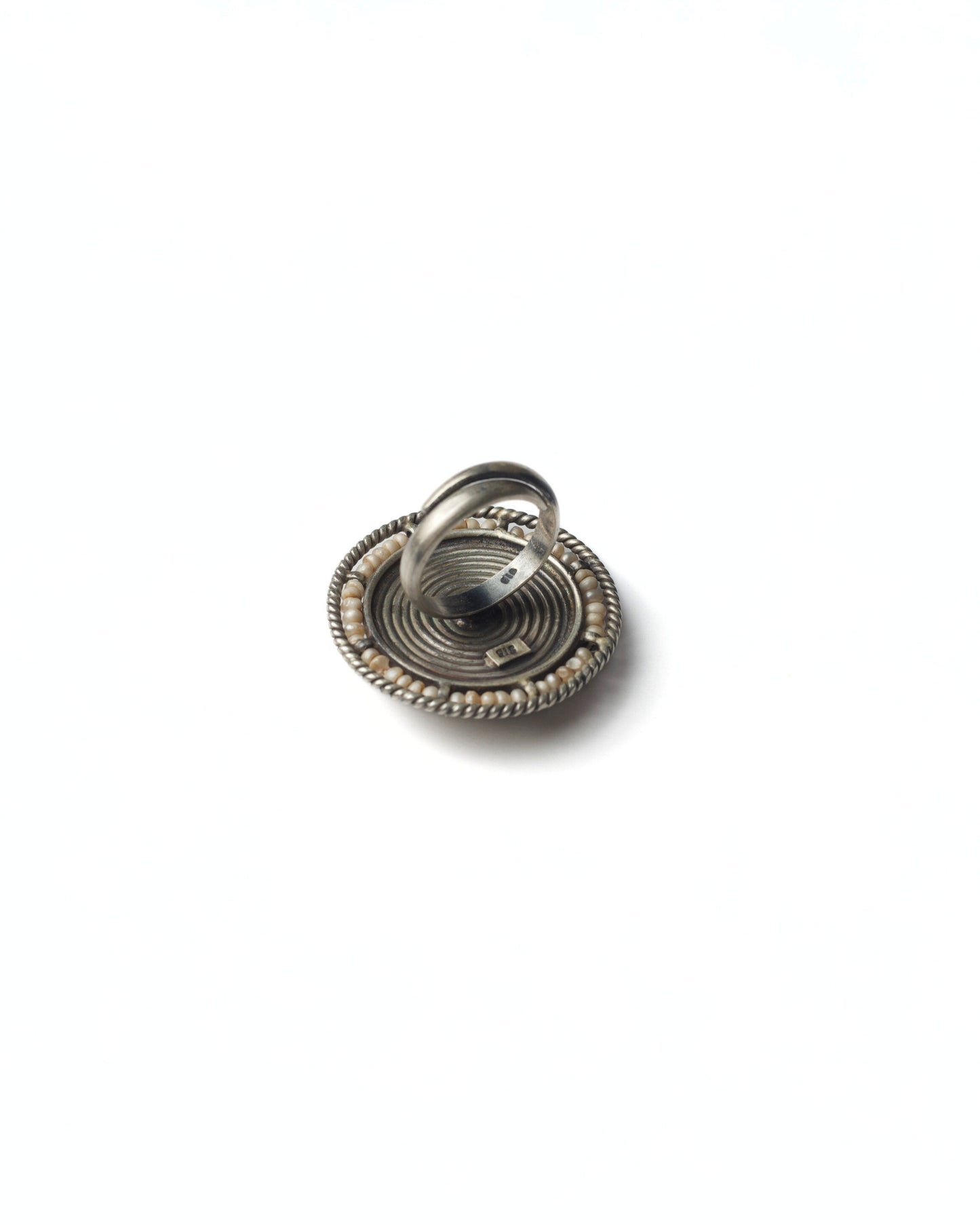 Back view of Bird Coil Ring highlighting solid 925 silver band and medallion-style construction
