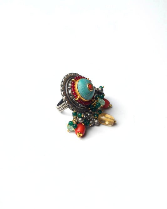 Side view of Turquoise Halo Ring showing raised circular medallion, layered silver halo, and bead drop movement