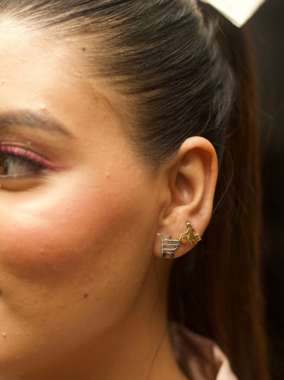Cha-Ching Studs by Naksa—mismatched silver shopping cart and gold shopper earrings in pure 925 silver.