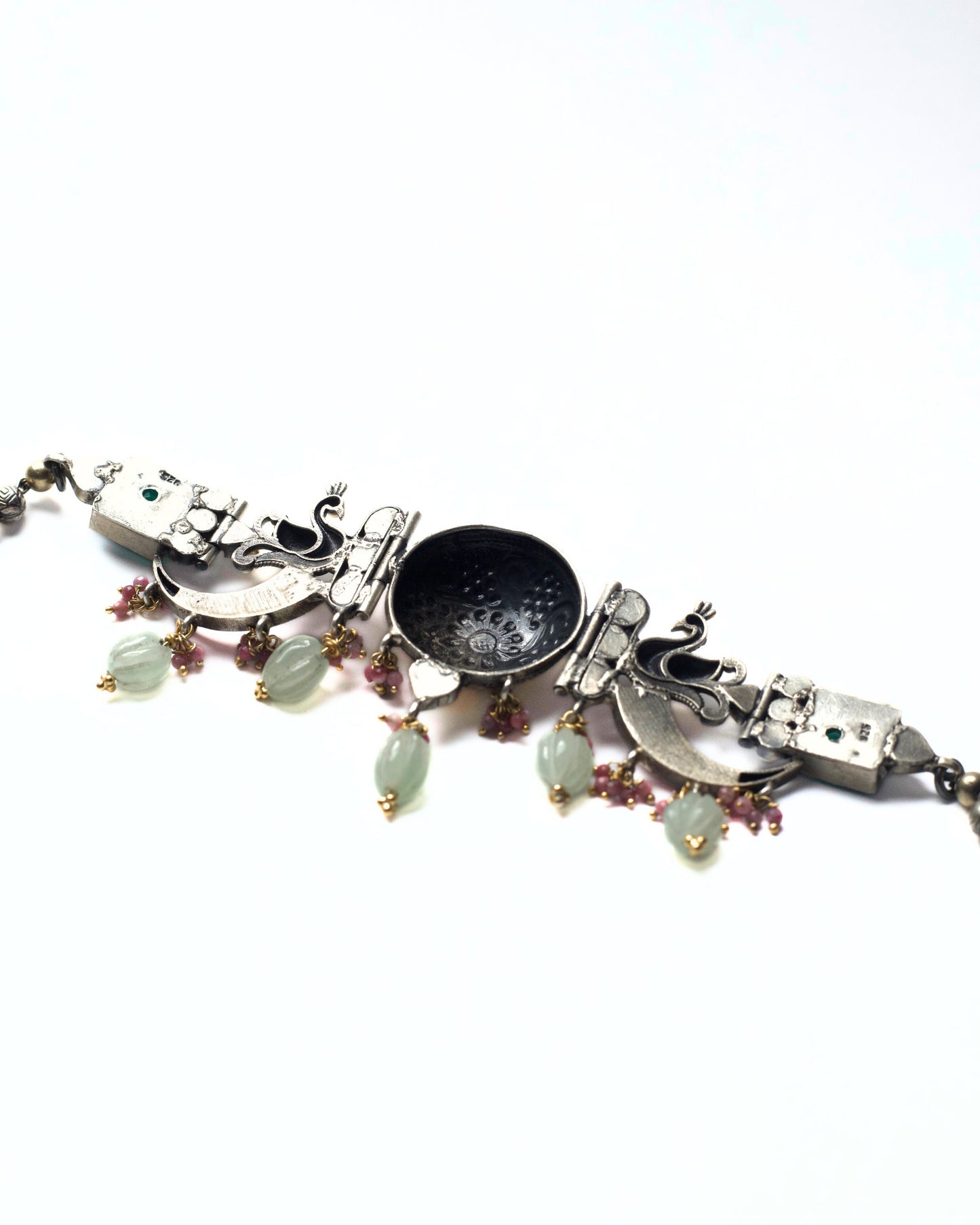 Back of the dual-tone dotted medallion with kundan-style detailing at the centre of The Peacock Halo Choker in pure 925 silver.