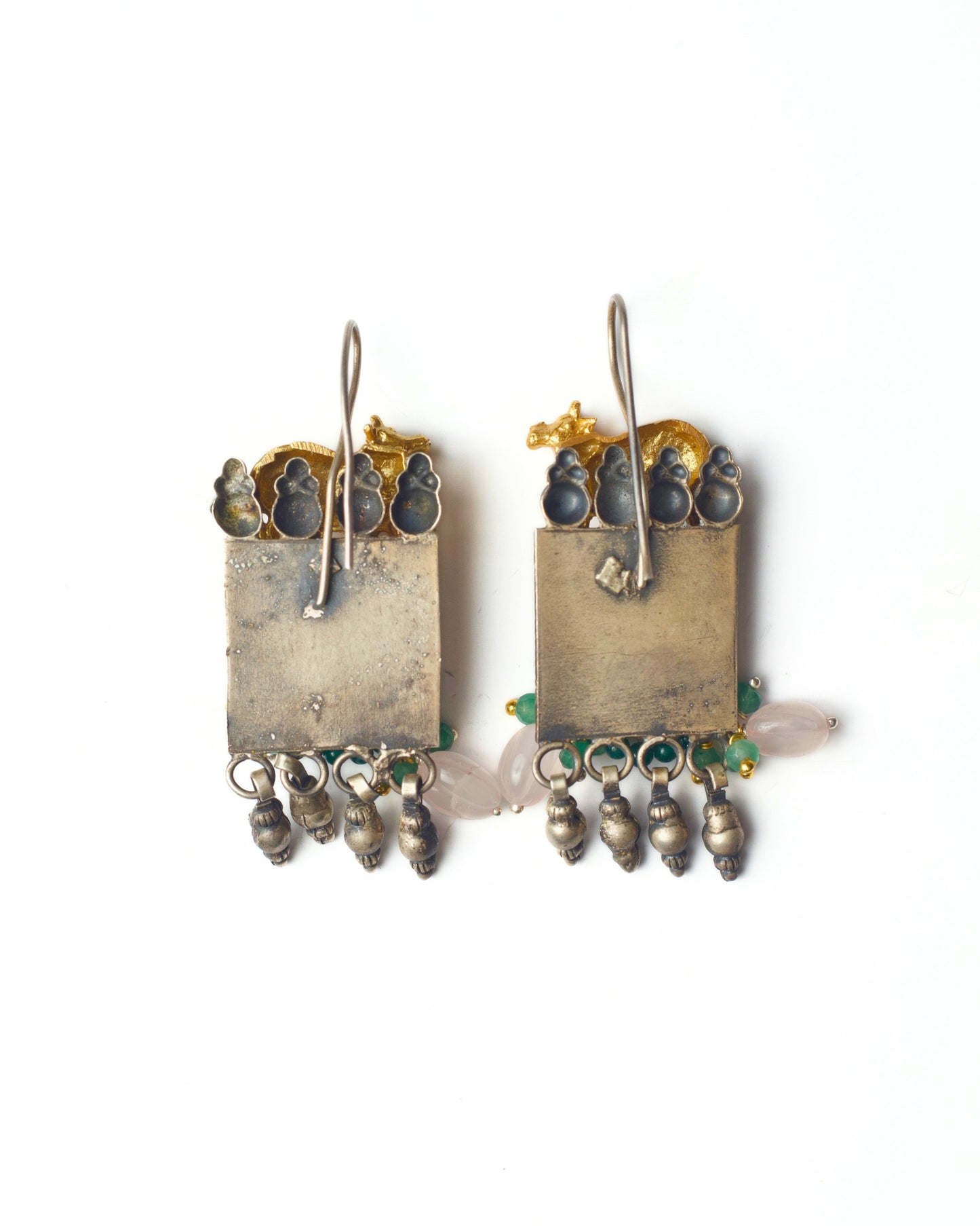 Back of nandi earrings with carved peacock base and ghunghroo detailing