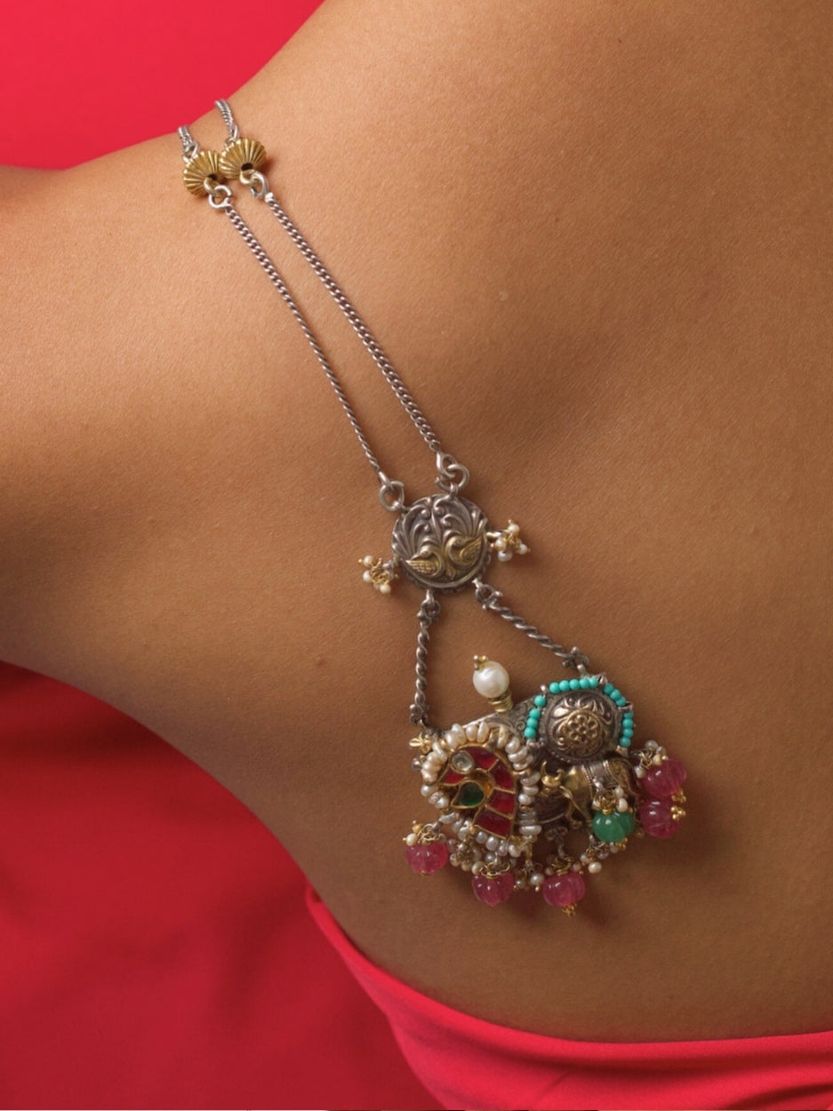 Close-up of 92.5 silver Pastel Panchali Necklace with cow motif, pearl outline, and multicolour pink-blue accents on a dual-tone silver-gold chain