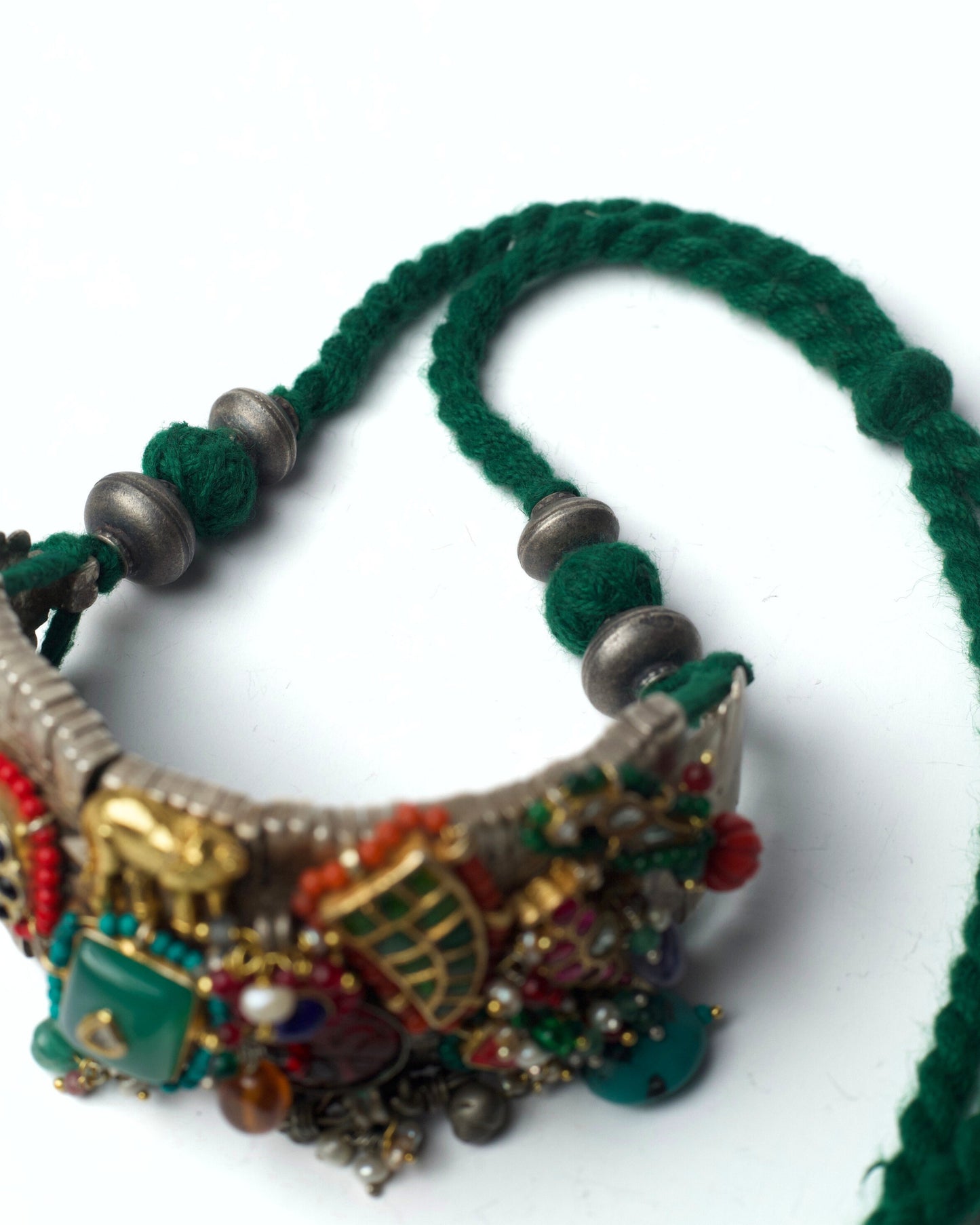 Upper view of Tusker Patchwork Choker showing layered beadwork, stone settings, and sculpted silver motifs on chatai base