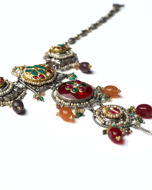 Close-up of deep red centre stone with kundan floral setting and pearl edging in a stacked heirloom choker
