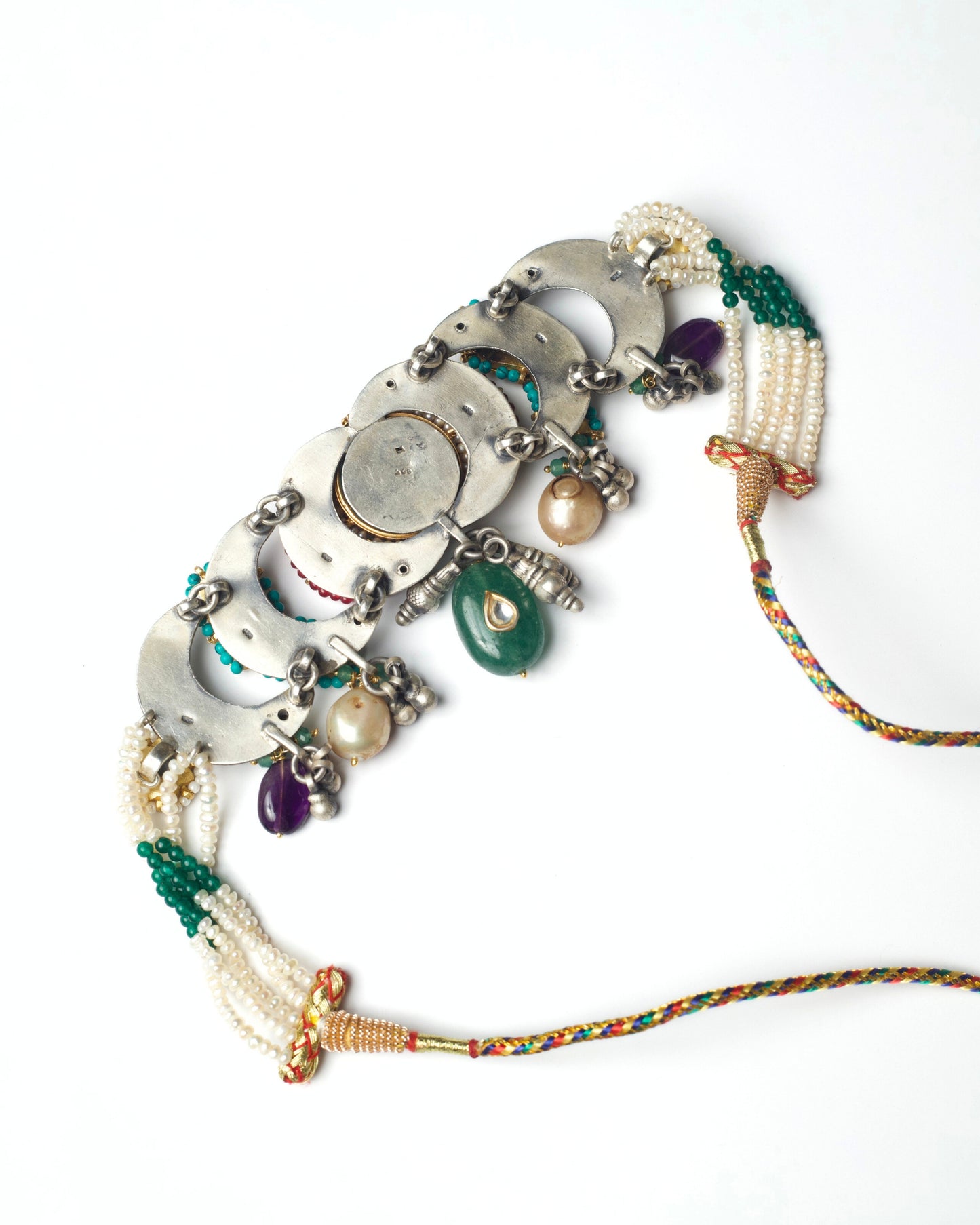 Back view of turquoise centre stone with kundan floral setting and crescent inlay work