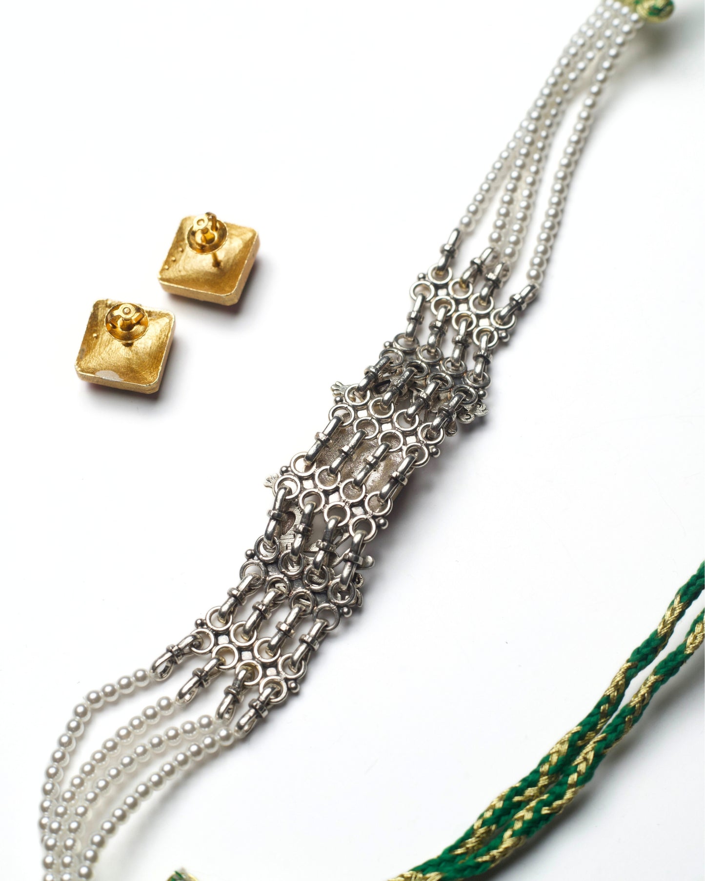 Back view of oxidised silver peacock frame choker set with square kundan centre and pearl side strands, paired with matching kundan stud earrings