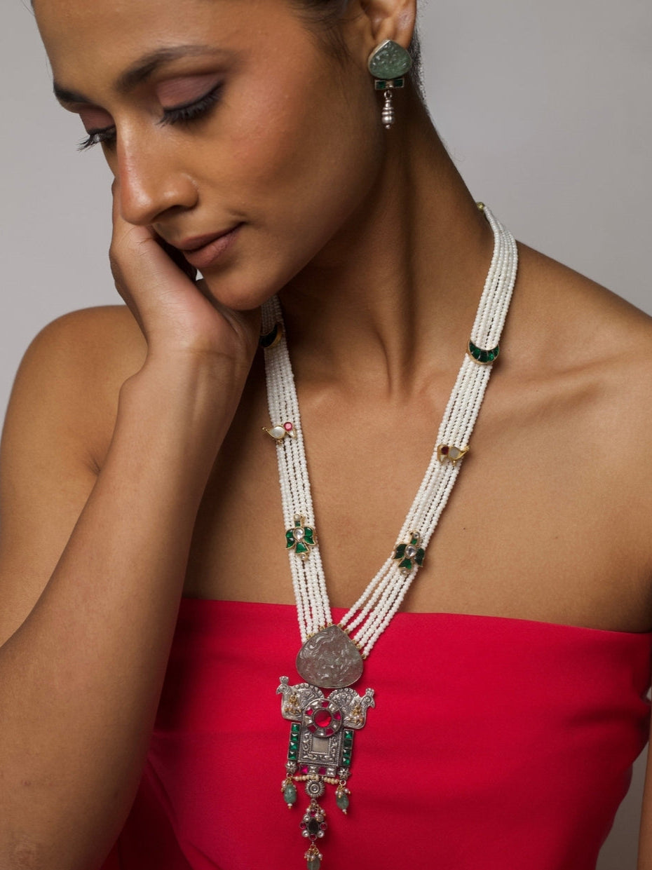 Five-strand Panchlada necklace in pure 92.5 silver with pearl beads, green carved stones, and a temple-style pendant featuring birds, moons, and intricate motifs. Styled with matching earrings.