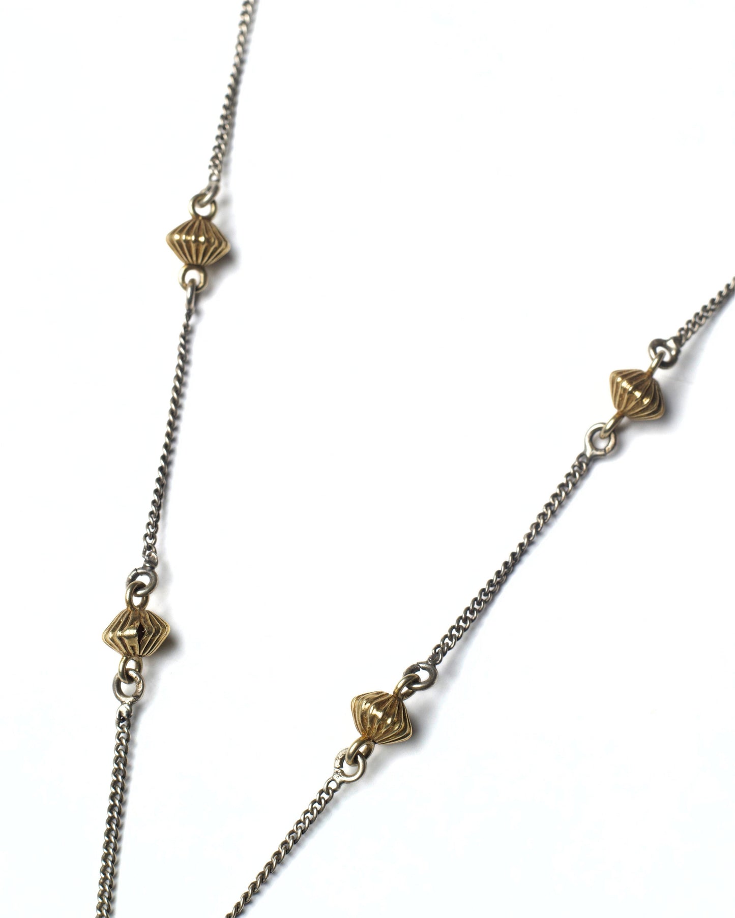 Silver chain detail of Fernshade Chain Necklace with fine links and textured metal accents