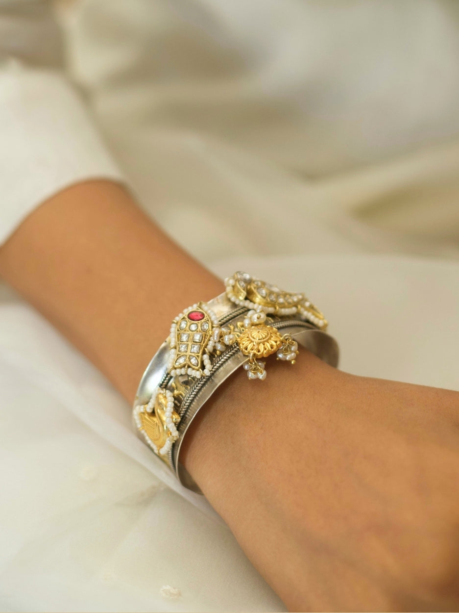 Intricate handcrafted bangle with camels, parrots, and pearl outline in 925 silver