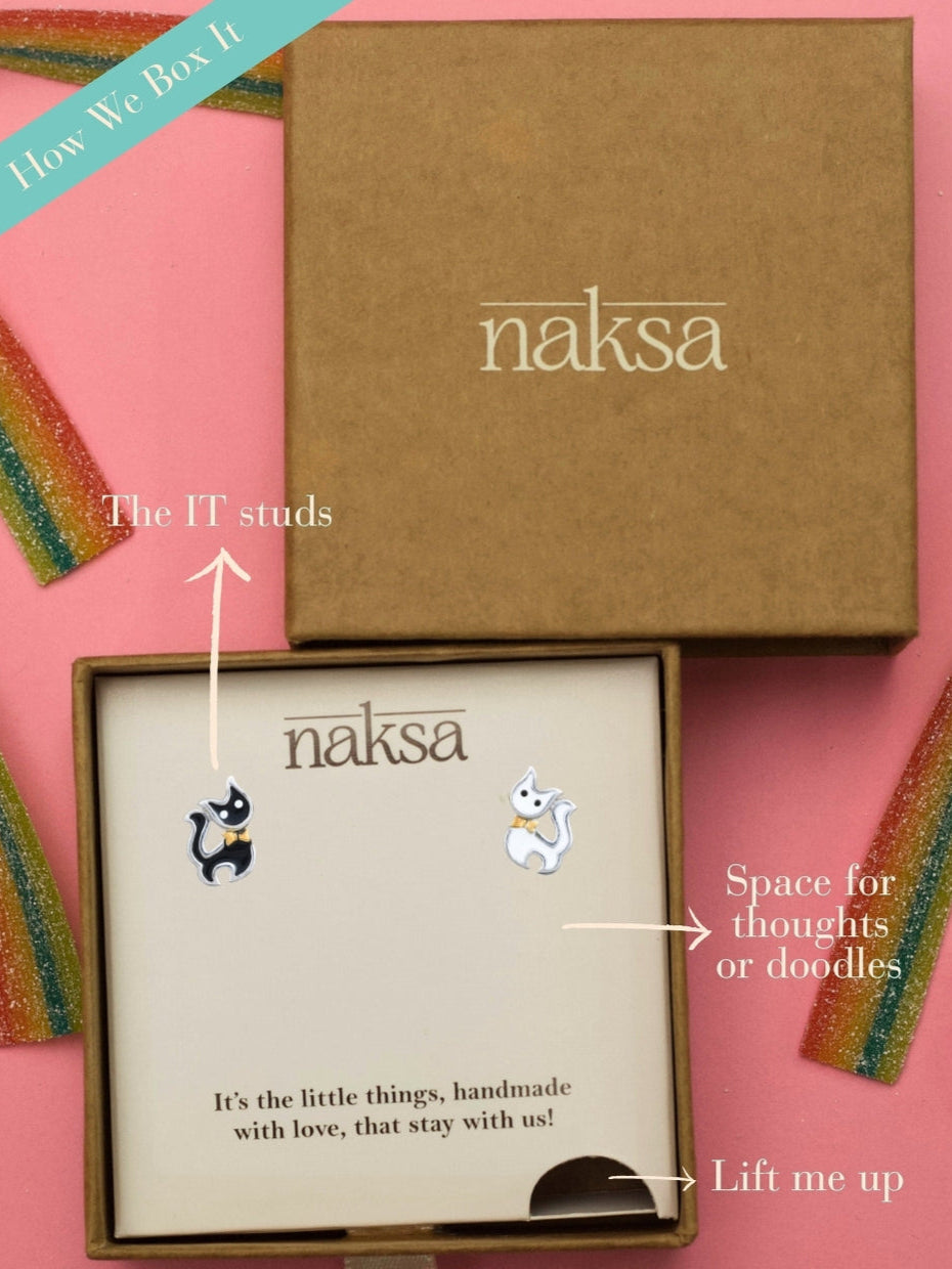 Mismatched Meows Studs by Naksa—black and white tuxedo cat earrings with golden bows, hand-enameled in pure 925 silver.