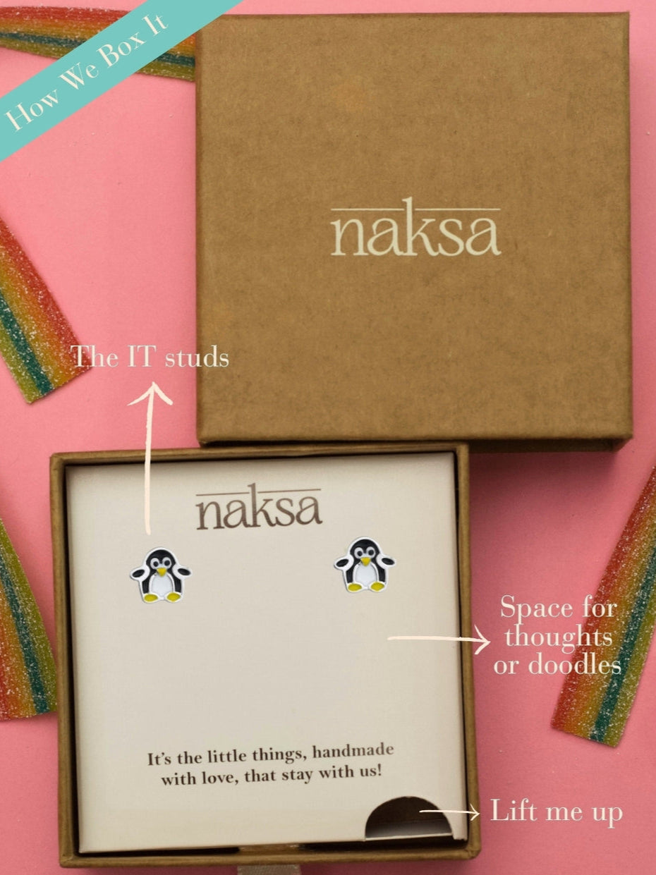 Waddle Waddle Studs by Naksa—cute penguin-shaped earrings in black, white, and yellow enamel on 925 silver, perfect for winter gifting.