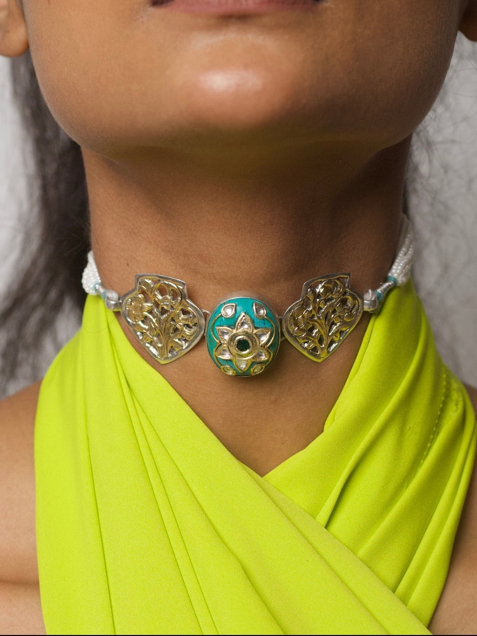 Model wearing Naksa’s Aqua Pop Choker in 92.5 silver, with turquoise enamel, floral jaali motifs, and pearl thread closure.