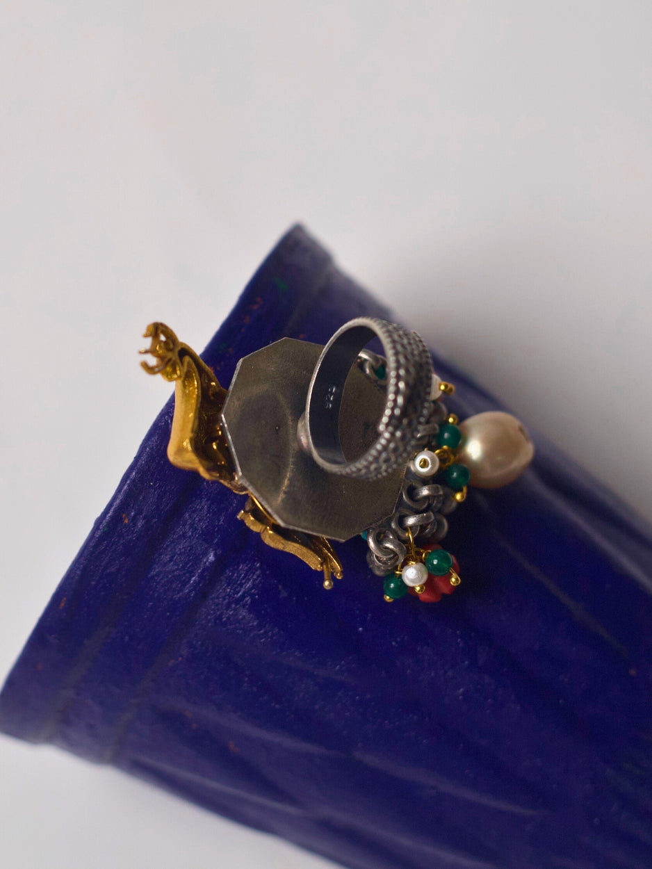Statement 92.5 silver ring featuring a gold deer motif, gemstone florals, and pearl drop – Naksa fusion jewelry