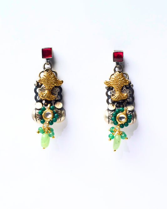The Fish & Fig Drops featuring a sculpted gold-toned fish motif, layered silver elements, green bead detailing, and a soft fig-green drop at the base.