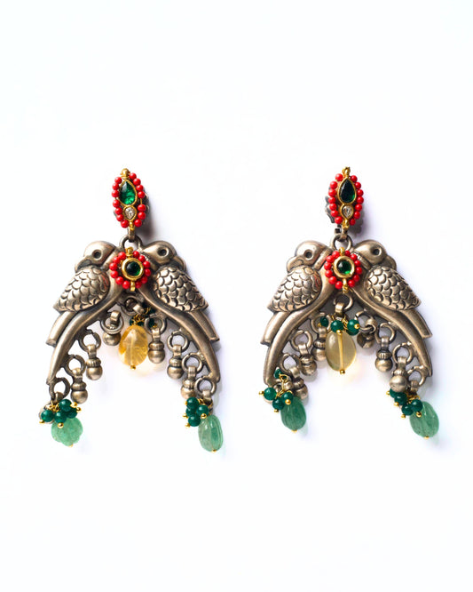 Front view of The Perched Parrots Earrings featuring twin parrot motifs with layered detailing and soft hanging elements in fusion silver jewellery.
