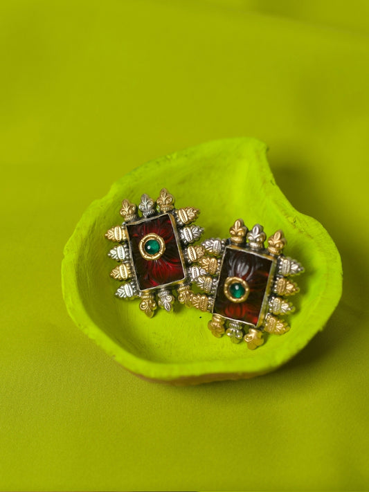 Close-up of handcrafted 92.5 silver rectangular studs with ruby red carved stone, green centre, and gold-silver temple detailing – Paan Patakha Studs by Naksa.