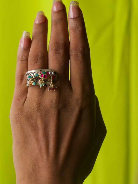 Close-up of handcrafted Birdie Bijou Silver Ring in 92.5 silver with meenakari bird motif, jhoomar danglers, and chatai texture, worn on a hand.