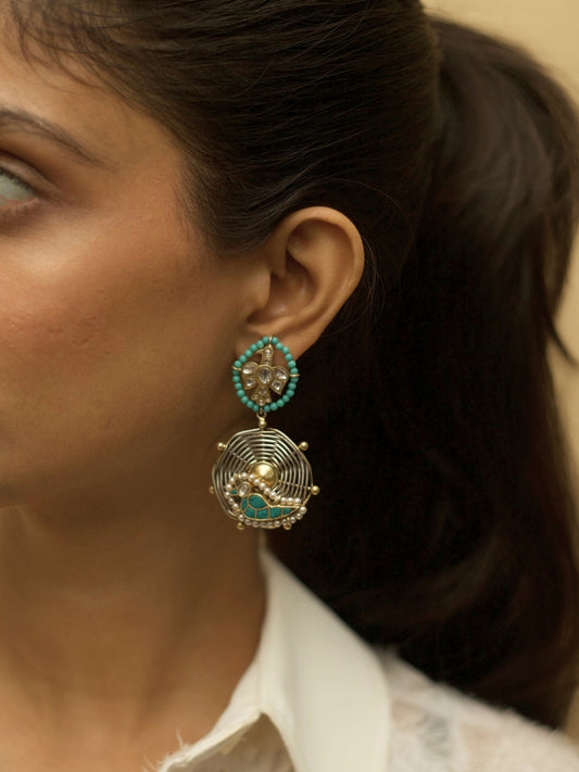 Sky Whisper Earrings in 925 silver with gold polish, eagle and parrot design, teal stone center – handcrafted by Naksa