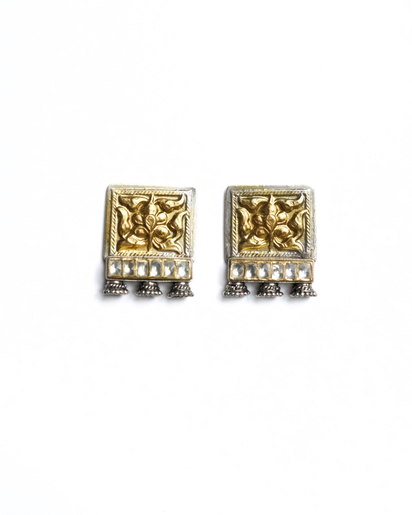 Square 925 silver stud earrings with gold polish, embossed floral motif, kundan-style stone row and small oxidised ghungroo drops from Naksa Playround collection.