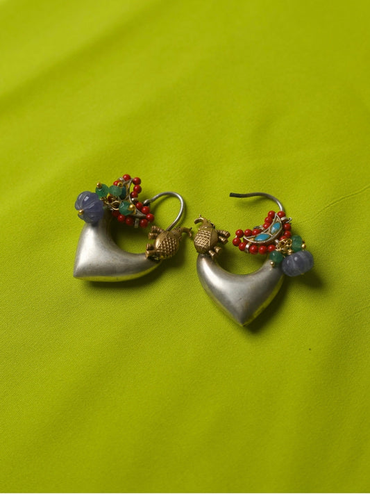 Heart-shaped handcrafted silver hoop earrings with enamel bird, violet beads, and red seed bead detailing