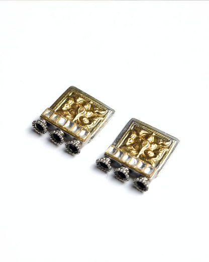 Square 925 silver stud earrings with gold polish, embossed floral motif, kundan-style stone row and small oxidised ghungroo drops from Naksa Playround collection.
