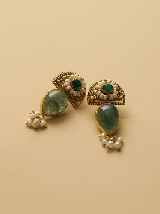 Aurora Drops Earrings by Naksa with golden half-sun motif, translucent green stone, and pearl accents.